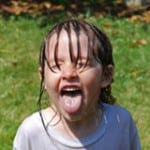 Child playing in a sprinkler