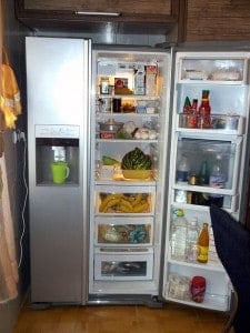 A side-by-side refrigerator-freezer with the refrigerator door open.