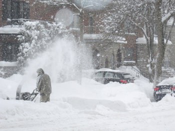 A map operates a snow blower after a heavy snowfall.