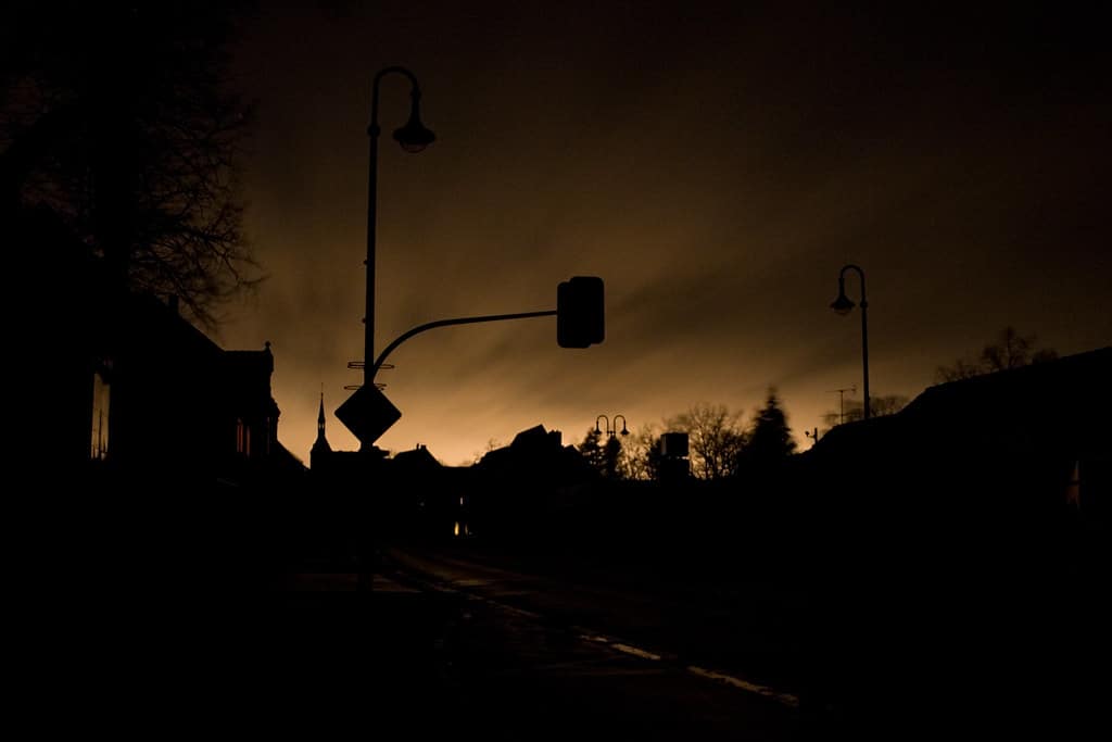 A power outage darkens the streets of a large city.
