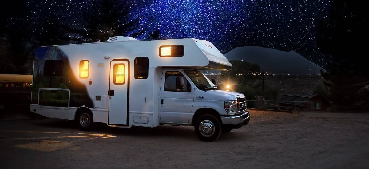 Class C Motorhome RV Camping with a night sky Milkyway Galaxy