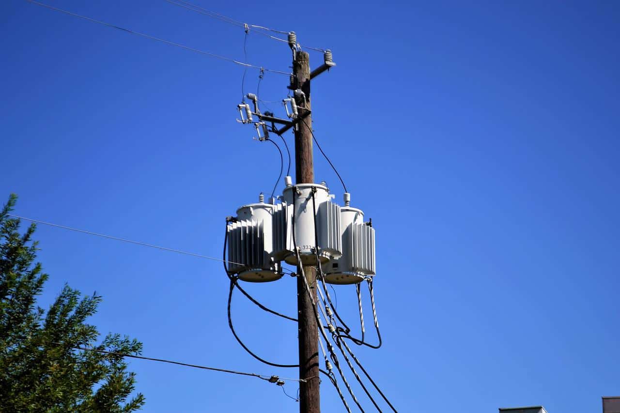 An electric utility pole with transformers and power lines.